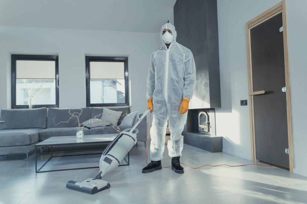 Man in White Suit Standing Beside White Wall